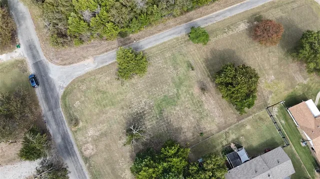 a view of a field with trees in background
