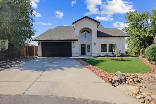 a front view of a house with a yard and garage