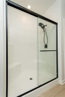 a bathroom with a glass shower door