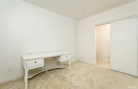 a room with a desk and a window