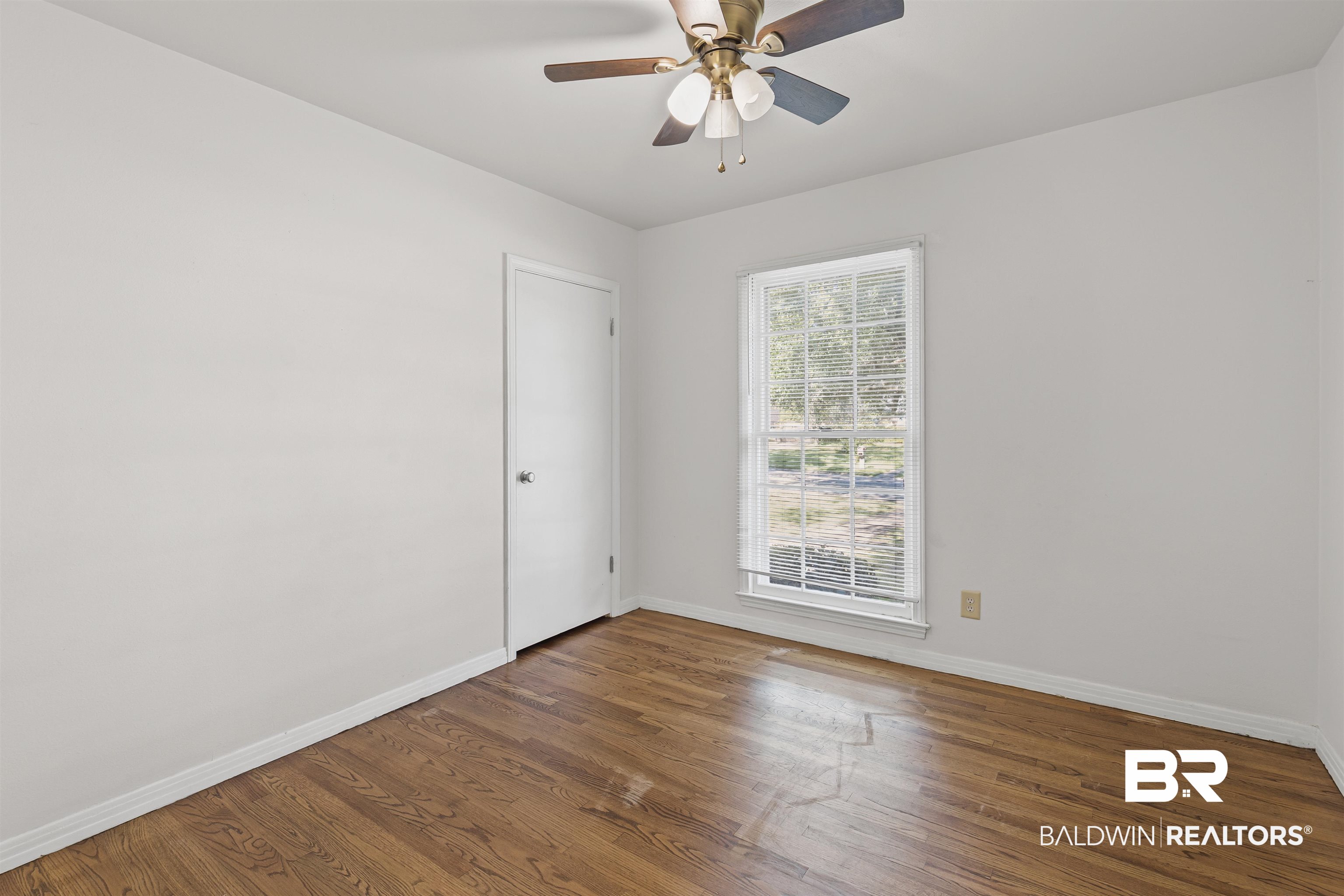 1108 Locarno Street Mobile, AL 36608 - Photo 14 of 24 Empty room with wood finished floors and a ceiling fan