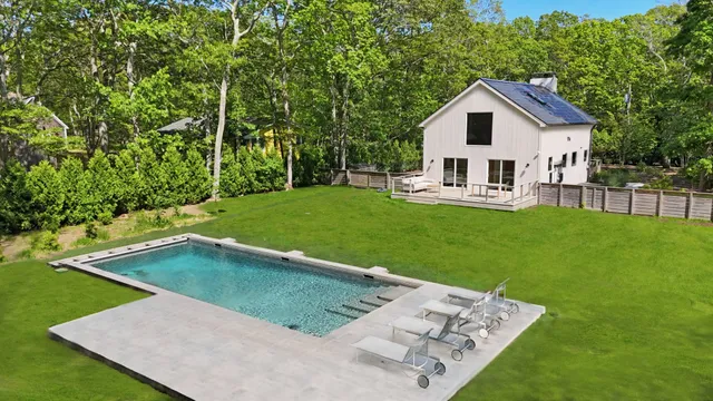 a view of a house with a yard and sitting area