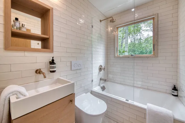 a bathroom with a sink a toilet and bathtub