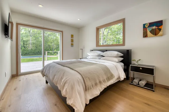 a bed sitting in a bedroom next to a window