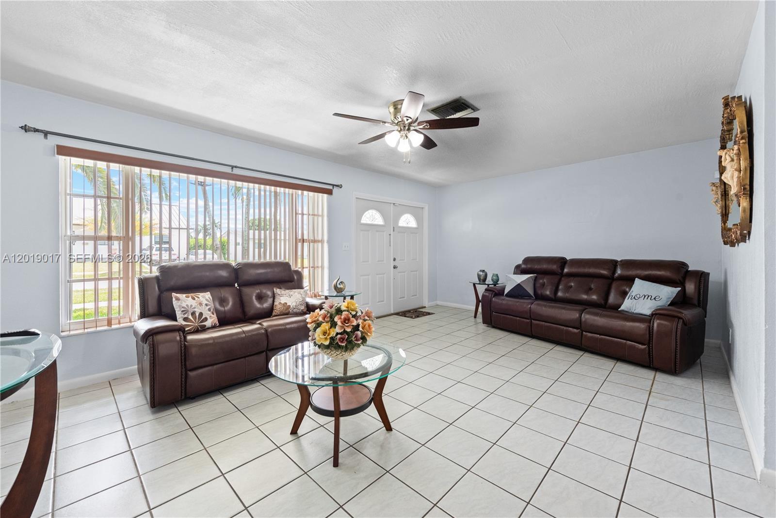 731 Northwest 17th Street Homestead, FL 33030 - Photo 2 of 29 a living room with furniture and a large window