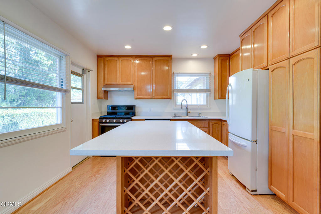 1360 Blackstone Road San Marino, CA 91108 - Photo 6 of 31 a kitchen with stainless steel appliances a refrigerator sink and cabinets