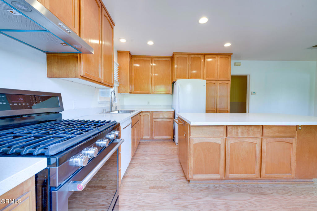 1360 Blackstone Road San Marino, CA 91108 - Photo 8 of 31 a kitchen with stainless steel appliances granite countertop a stove a sink and a microwave