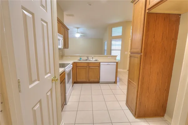 a view of a kitchen with white cabinets