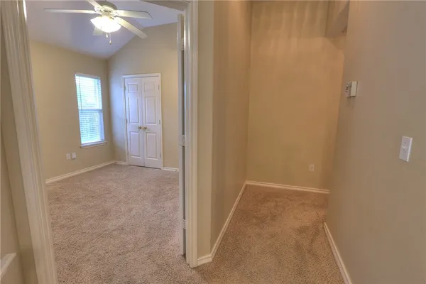 a view of a livingroom with a ceiling fan and window
