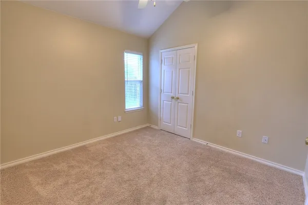 an empty room with windows and closet