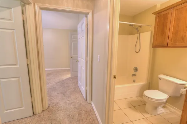 a bathroom with a toilet and shower
