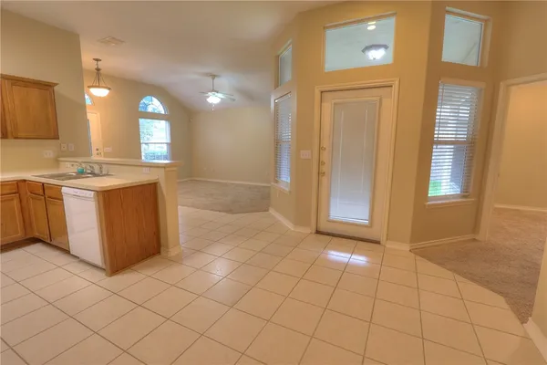 a view of a kitchen with a sink and cabinets