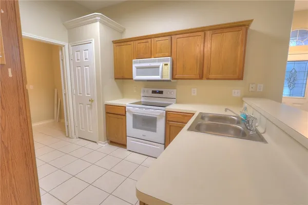 a kitchen with a sink cabinets and appliances