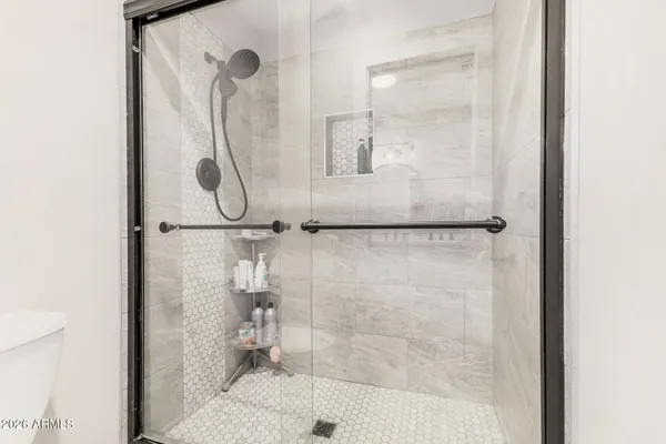a bathroom with a glass shower door