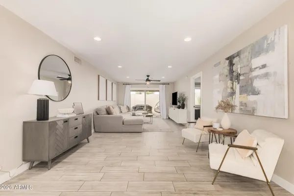 a living room with furniture a mirror and a sink