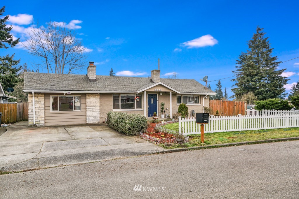 3601 Northeast 9th Street Renton, WA 98056 - Photo 2 of 23 a front view of a house with a yard and garage
