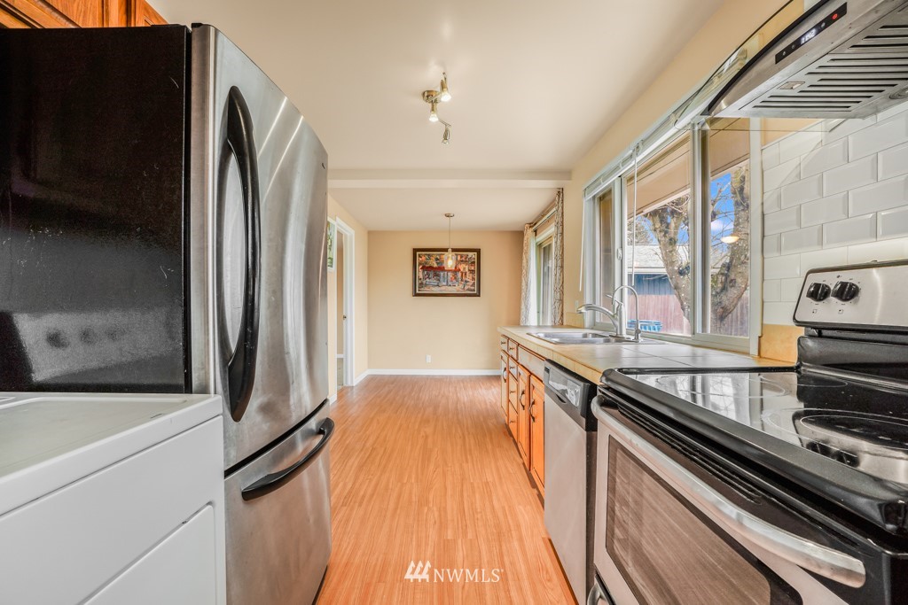 3601 Northeast 9th Street Renton, WA 98056 - Photo 12 of 23 a kitchen with stainless steel appliances granite countertop a refrigerator and a stove top oven