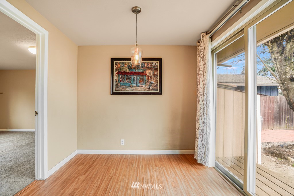 3601 Northeast 9th Street Renton, WA 98056 - Photo 13 of 23 a view of an empty room with wooden floor and a window