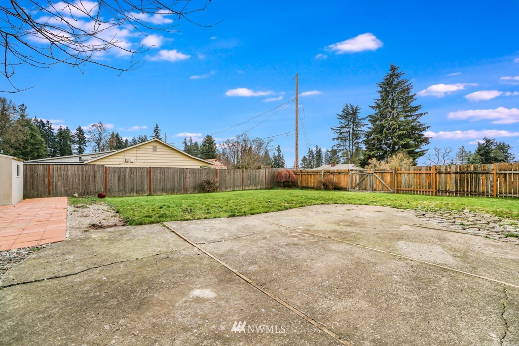 3601 Northeast 9th Street Renton, WA 98056 - Photo 21 of 23 a view of a yard with an tree and wooden fence