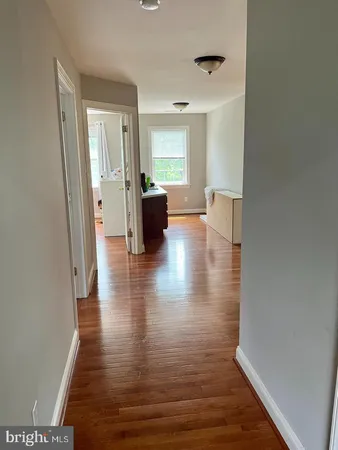 a view of living room with furniture and wooden floor