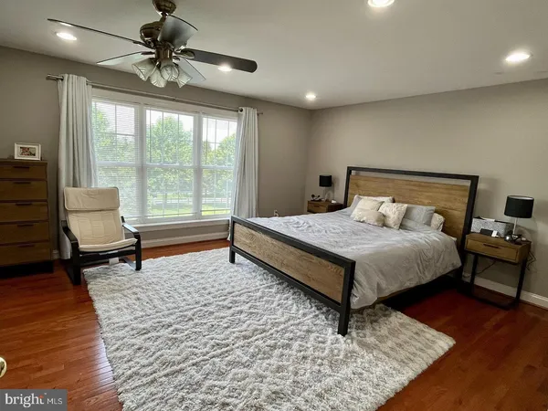 a bedroom with a bed a lamp and a rug