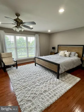 a bedroom with a bed and large window