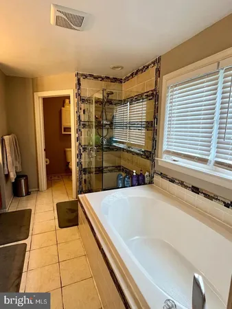 a bathroom with a bathtub and a shower