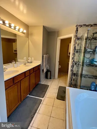a bathroom with a double vanity sink and a mirror