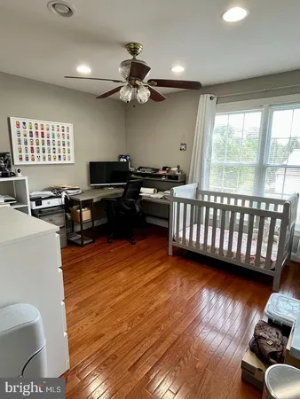 a view of a livingroom with furniture hardwood floor and a ceiling fan