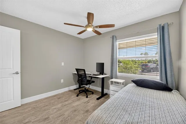 a living room with furniture a chandelier and a large window
