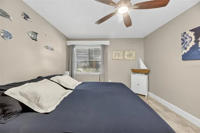 a view of a lake with a table and chairs under an umbrella