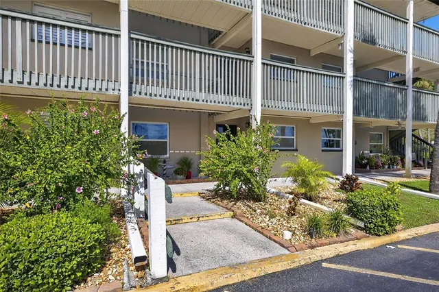 a living room with furniture chandelier and a wooden floor