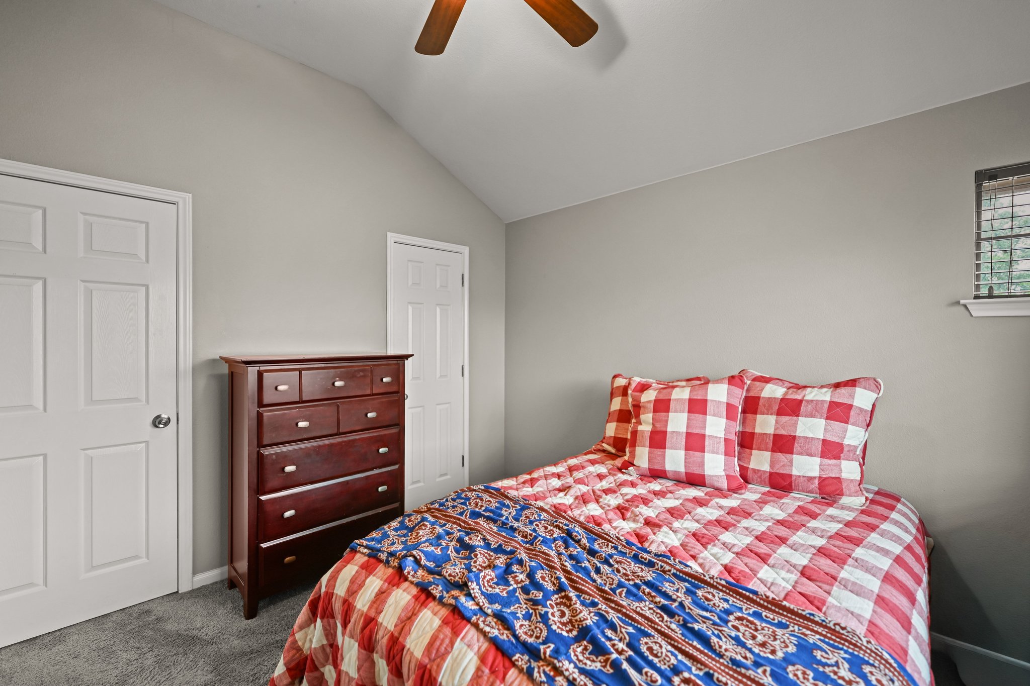5528 Wild Foxglove Road Spicewood, TX 78669 - Photo 31 of 38 a bedroom with a bed and cabinets