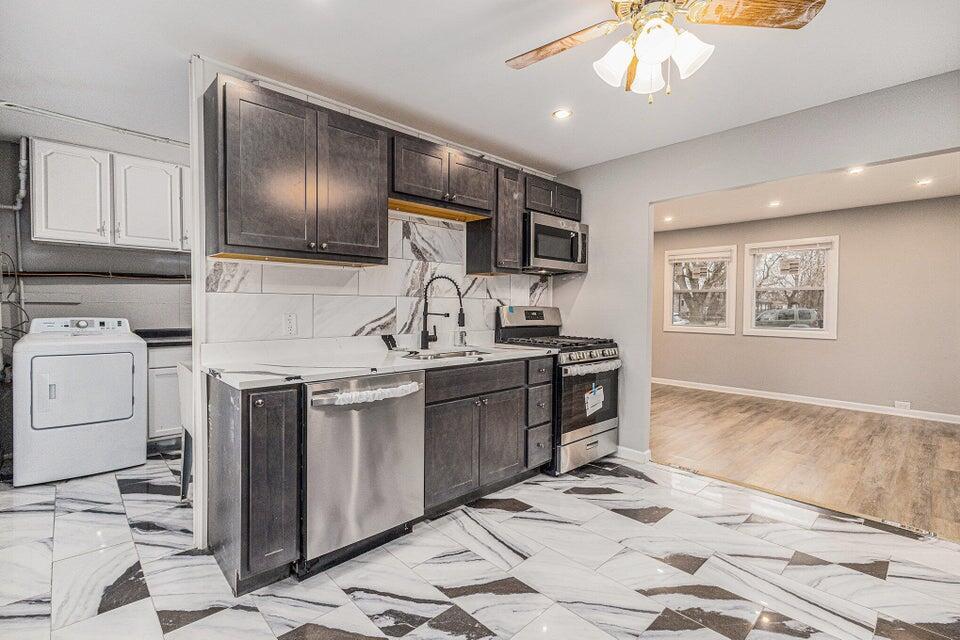 5207 West 4th Place Gary, IN 46406 - Photo 2 of 15 a kitchen with a sink stove and refrigerator