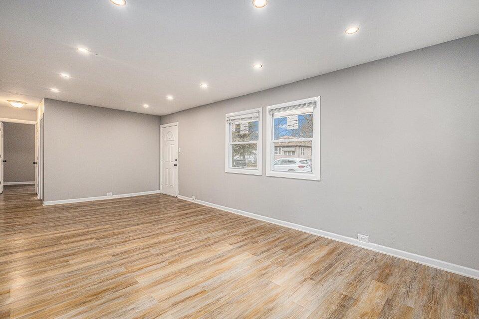 5207 West 4th Place Gary, IN 46406 - Photo 5 of 15 an empty room with wooden floor and windows