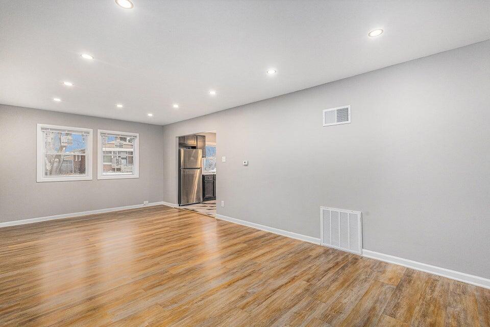 5207 West 4th Place Gary, IN 46406 - Photo 6 of 15 an empty room with wooden floor and windows