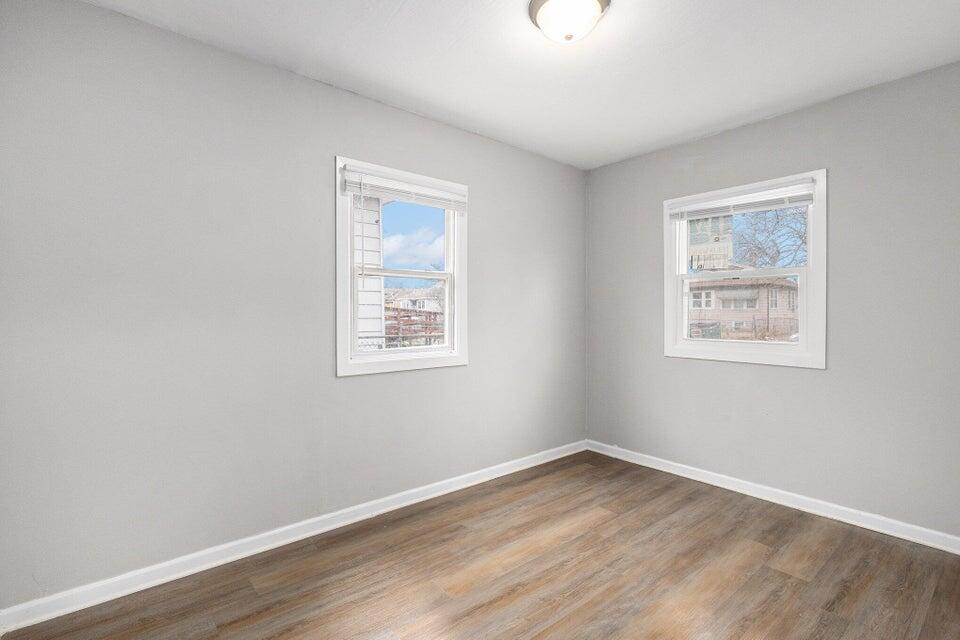 5207 West 4th Place Gary, IN 46406 - Photo 9 of 15 a view of an empty room with wooden floor and a window