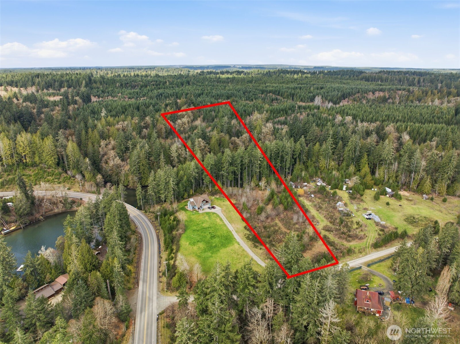 0 East McLane Cv Drive Grapeview, WA 98546 - Photo 1 of 20 a view of a city with lush green forest