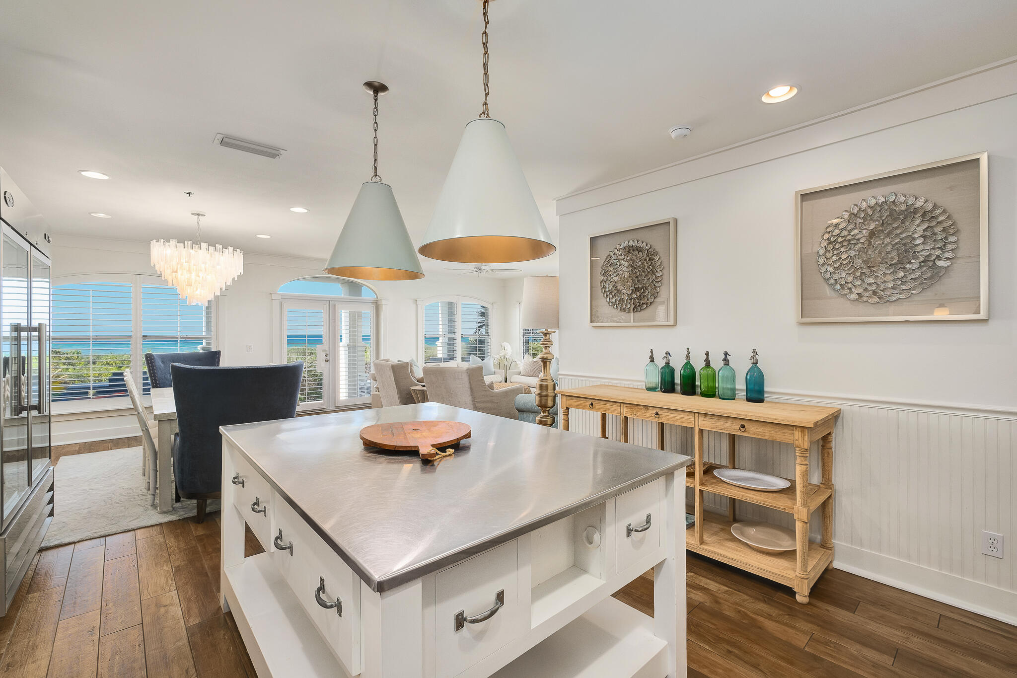 10140 East County Highway 30A, Unit A102 Inlet Beach, FL 32461 - Photo 7 of 37 a kitchen with stainless steel appliances granite countertop a stove a dining table chairs and white cabinets