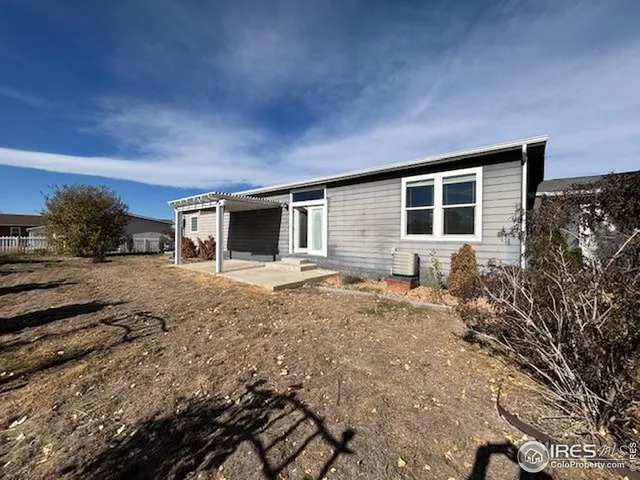 a backyard of a house with yard and outdoor seating