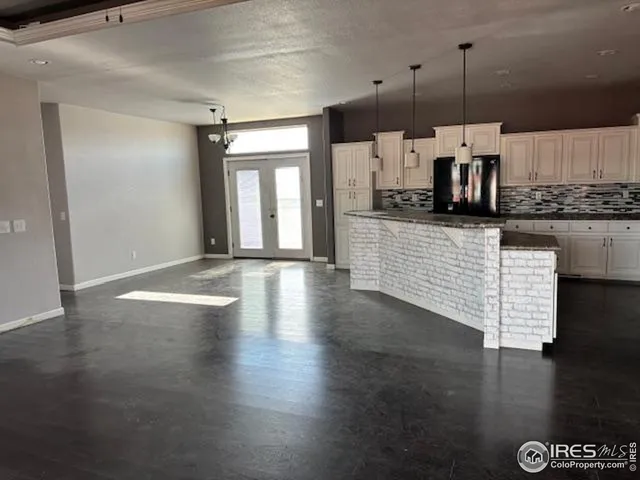 a kitchen with granite countertop a stove and a wooden floor