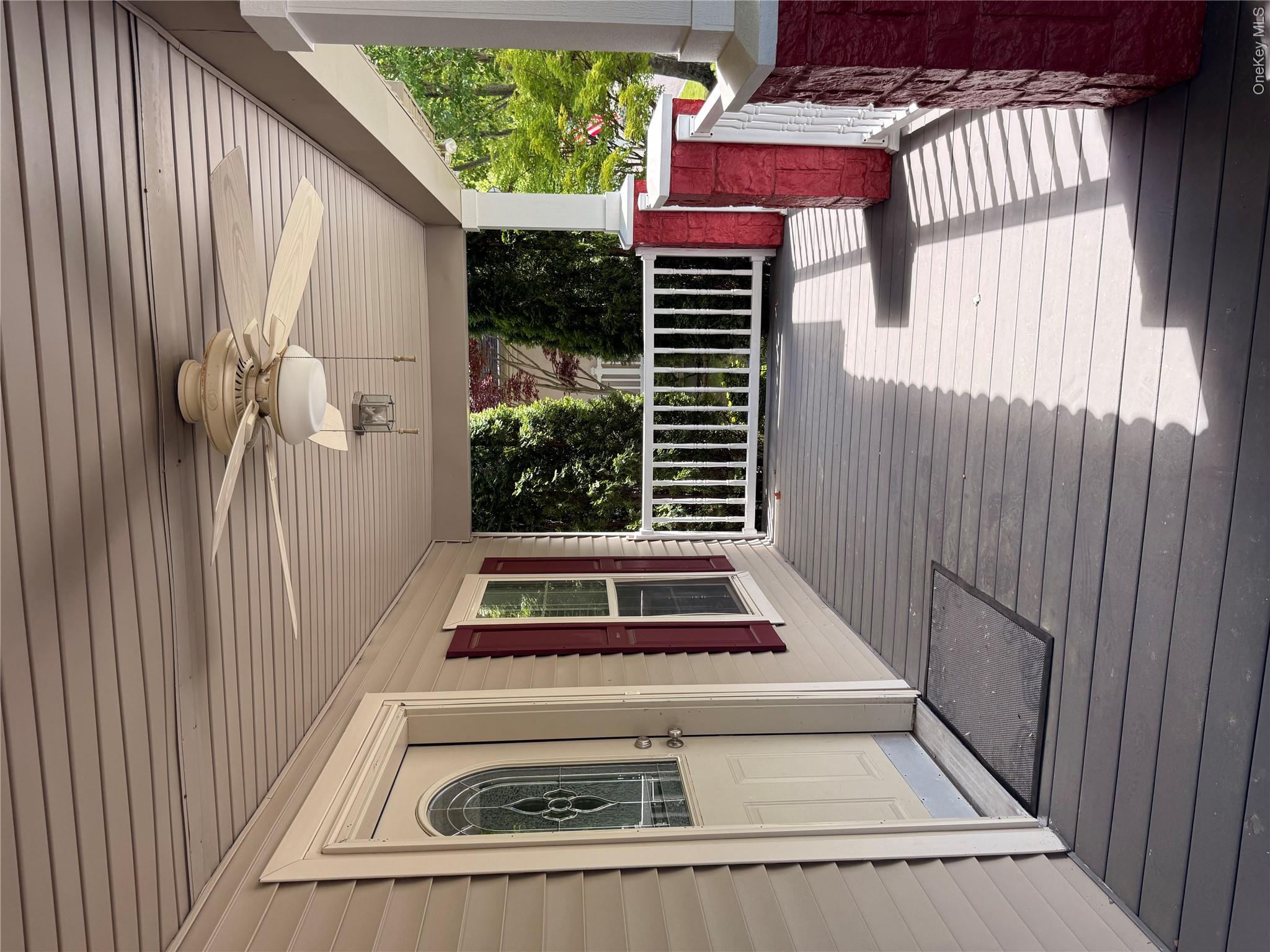 1661 Old Country Road, Unit 516 Riverhead, NY 11901 - Photo 6 of 50 a view of balcony with wooden floor and outdoor seating
