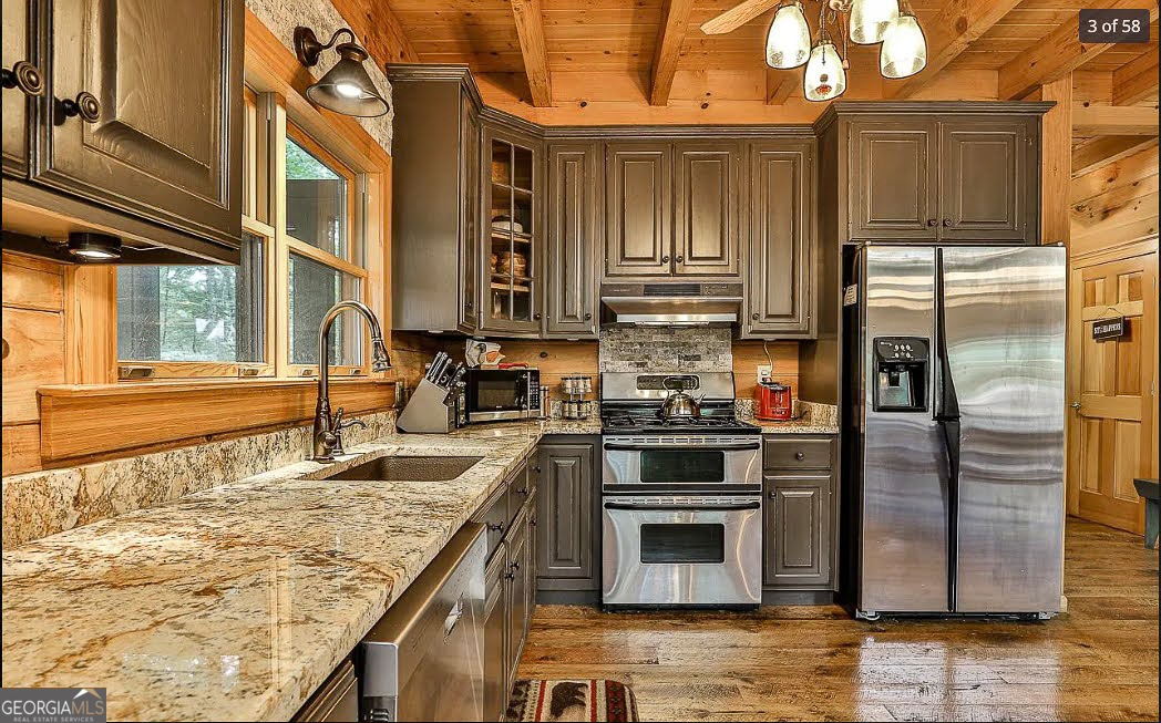 1427 Cherry Lake Drive Blue Ridge, GA 30513 - Photo 14 of 89 a kitchen with stainless steel appliances granite countertop a stove a sink and a refrigerator