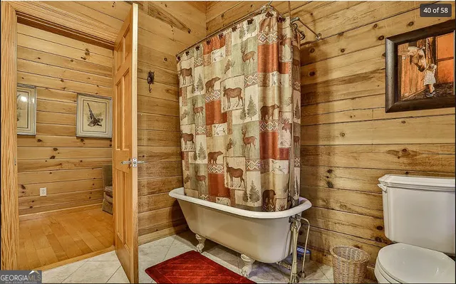 a bedroom with a bed and a flat tv screen on the dresser