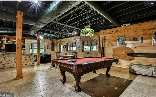 a large bed sitting in a bedroom next to a window