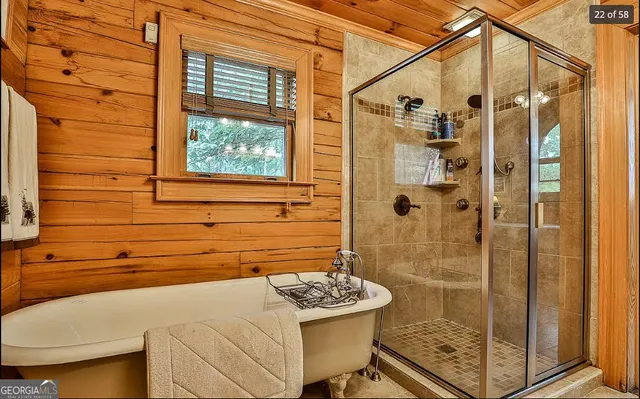 an aerial view of a house with a yard and large trees