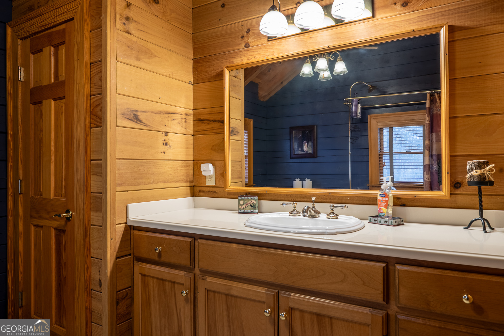 1427 Cherry Lake Drive Blue Ridge, GA 30513 - Photo 34 of 89 a bathroom with a sink and a mirror