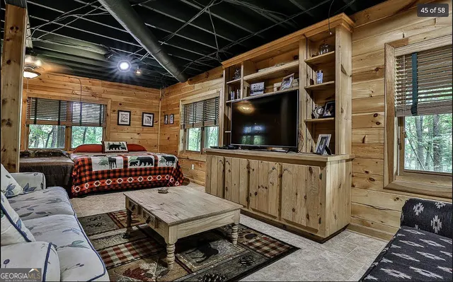 a living room with chairs and a rug