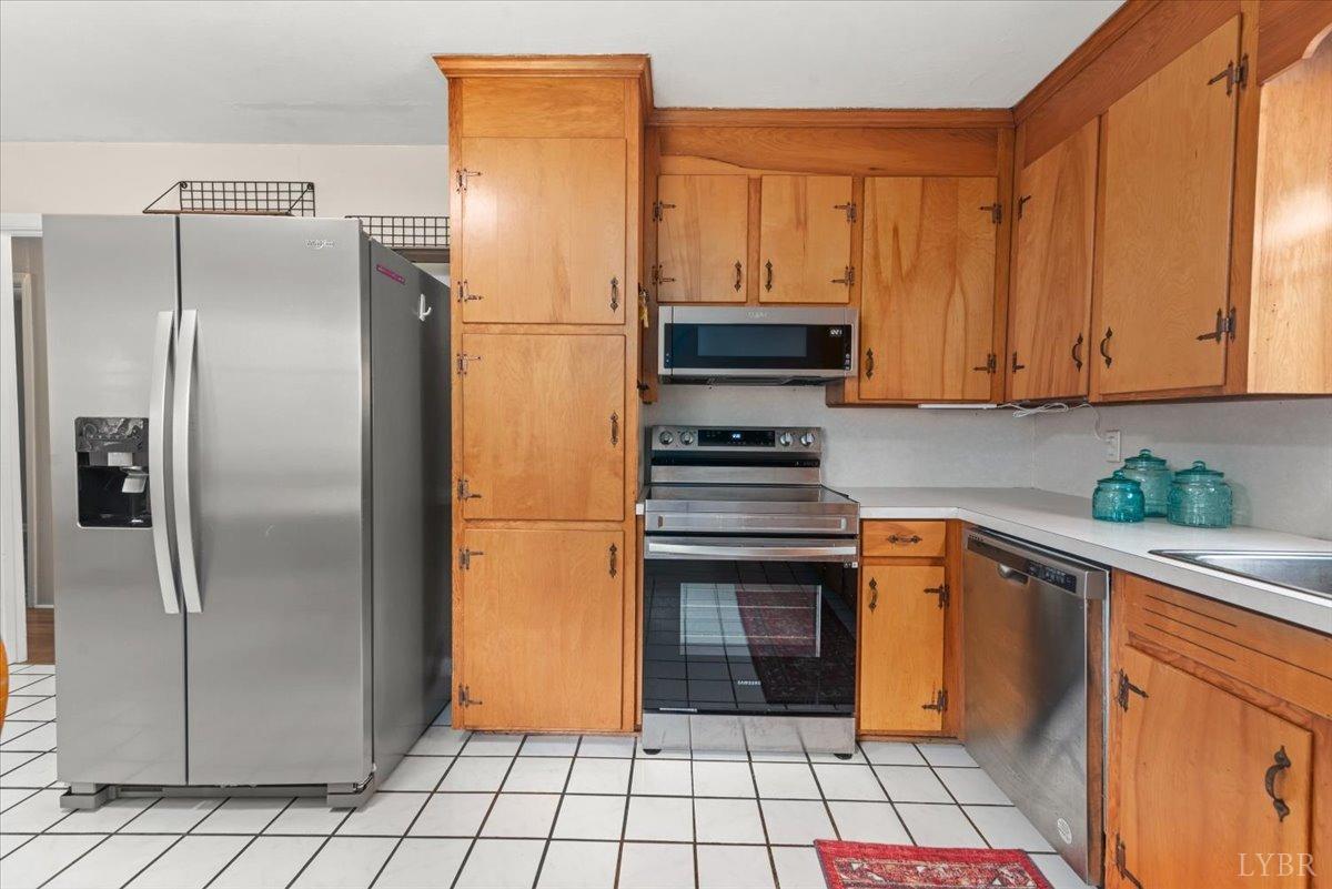 1752 Purdum Mill Road Appomattox, VA 24522 - Photo 12 of 38 a kitchen with stainless steel appliances a refrigerator sink and cabinets