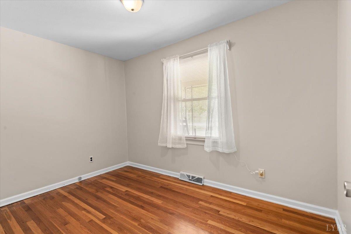 1752 Purdum Mill Road Appomattox, VA 24522 - Photo 16 of 38 wooden floor in an empty room with a window